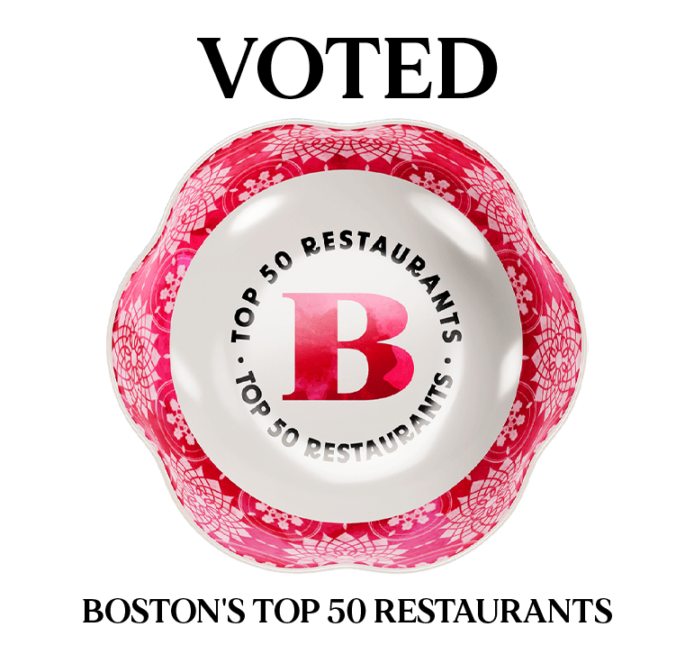 Boston Magazine’s Top 50 Restaurants badge with red decorative border and bold letter B in the center.